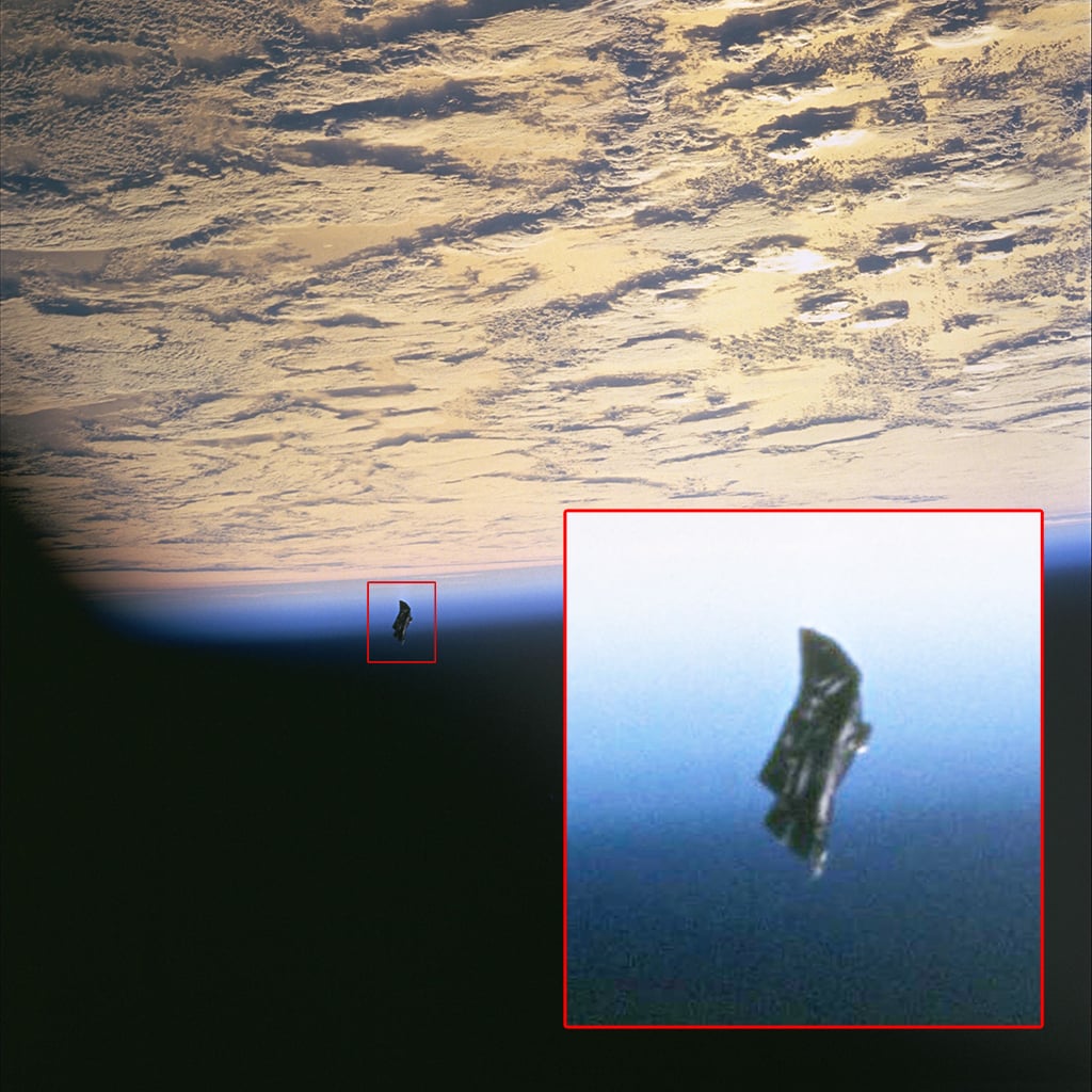 The Black Knight Satellite orbiting the earth taken from the space shuttle